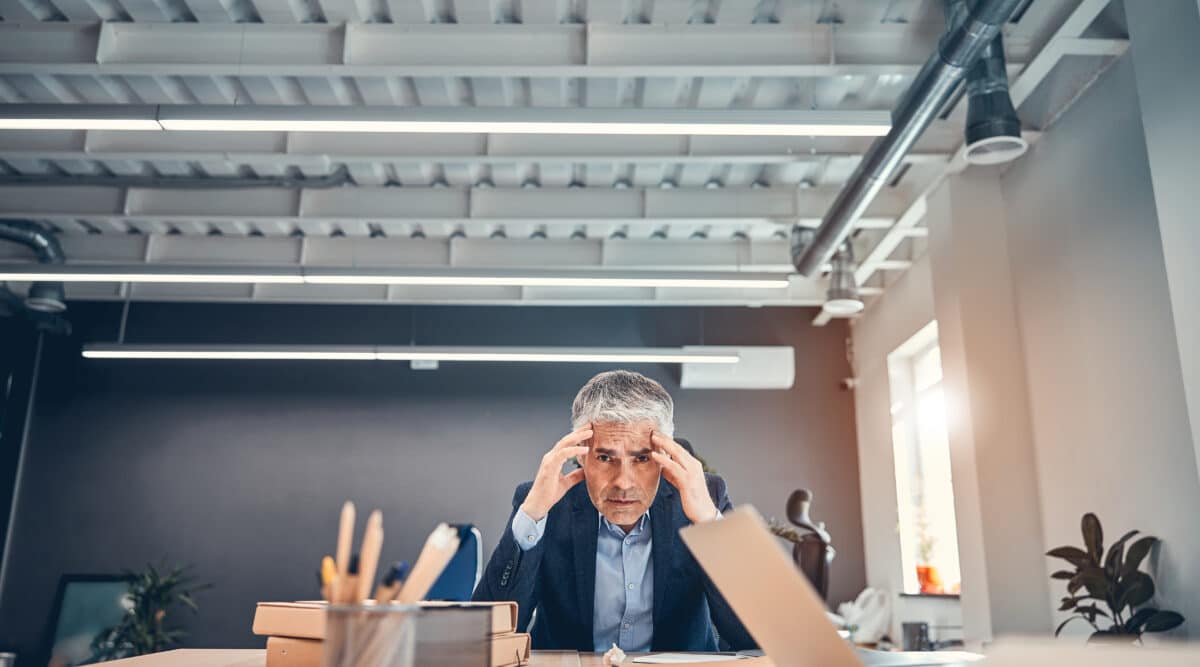 A man suffering from high-functioning ptsd working in an office.