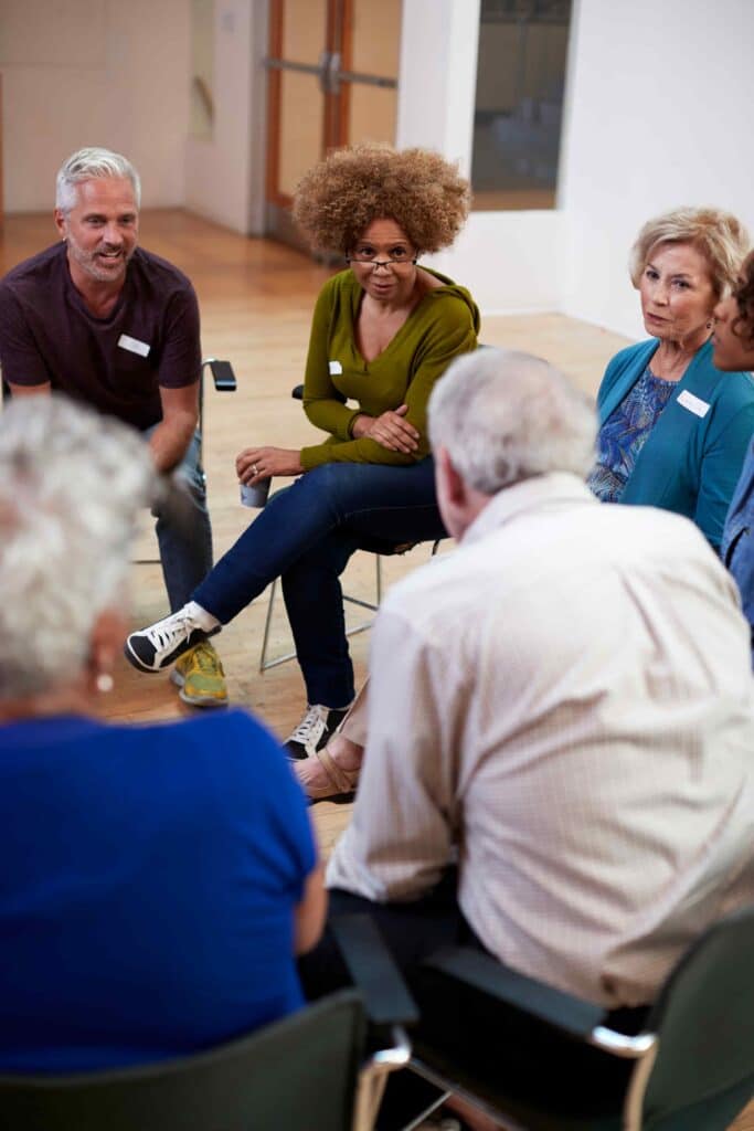 people attending group therapy sitting in a circle