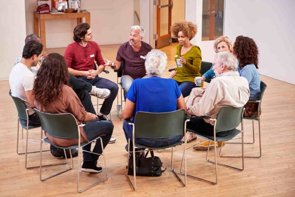 Adults sitting in a circle during a group therapy session